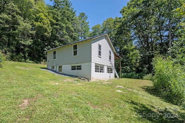 view of side of home with a lawn