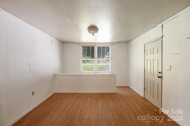 empty room with hardwood / wood-style flooring