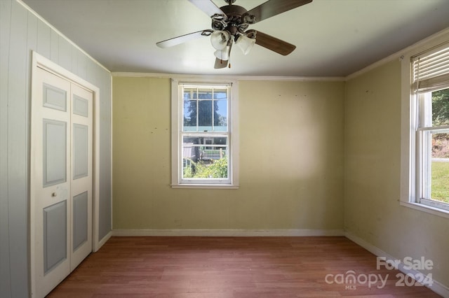 interior space featuring ornamental molding, hardwood / wood-style floors, ceiling fan, and a closet