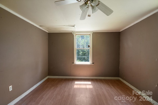 unfurnished room with ceiling fan, hardwood / wood-style flooring, and ornamental molding