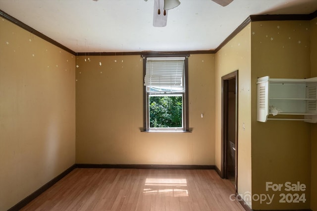 unfurnished room with crown molding, ceiling fan, and light wood-type flooring