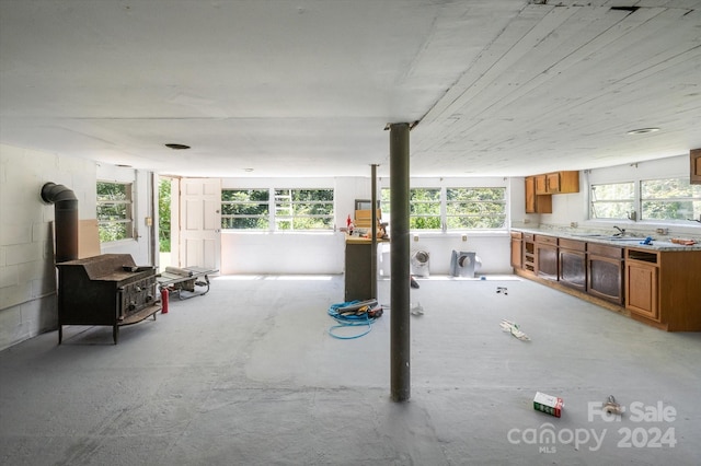 interior space featuring a healthy amount of sunlight and a wood stove