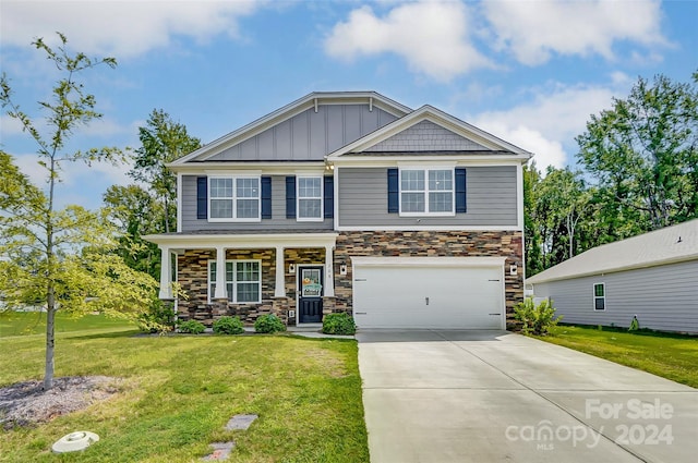 craftsman-style home featuring a porch, a front yard, and a garage