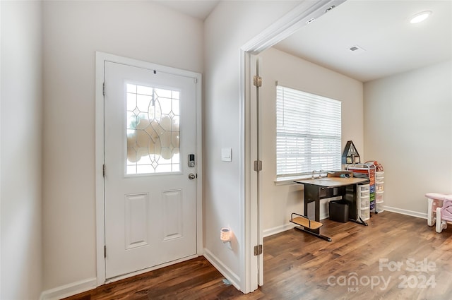 foyer entrance featuring wood finished floors and baseboards