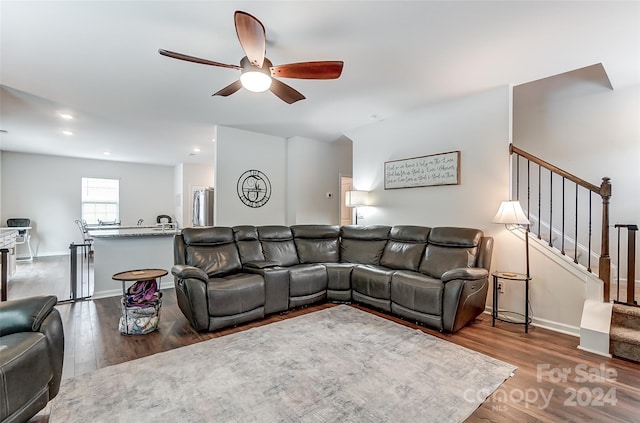 living area featuring recessed lighting, a ceiling fan, baseboards, stairs, and dark wood finished floors