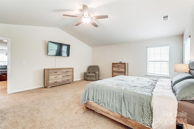 bedroom with visible vents, vaulted ceiling, light carpet, and baseboards