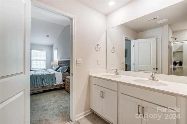 ensuite bathroom featuring double vanity, visible vents, a sink, and ensuite bathroom