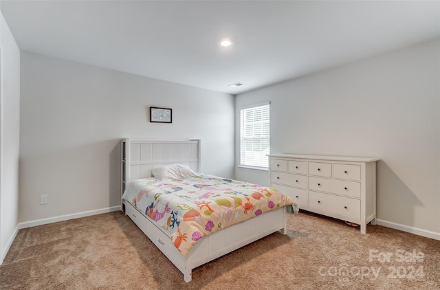 bedroom featuring light colored carpet, visible vents, and baseboards