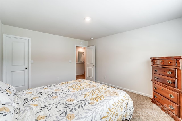 bedroom featuring light carpet and baseboards