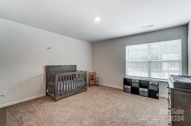 carpeted bedroom with visible vents and baseboards