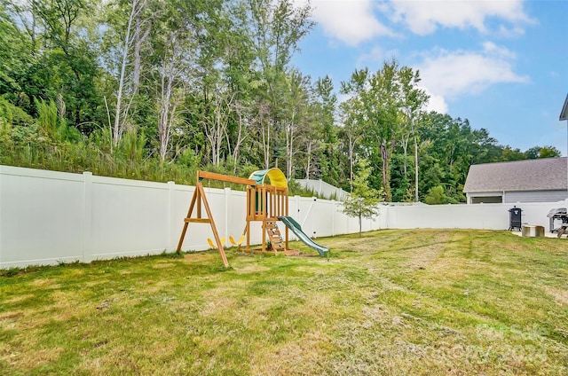 view of yard featuring a fenced backyard and a playground