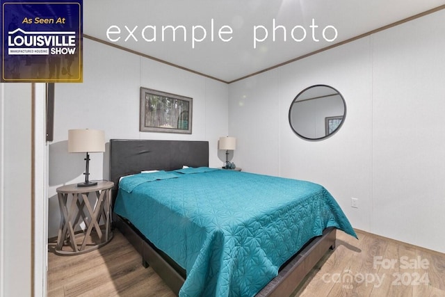 bedroom with hardwood / wood-style flooring and crown molding