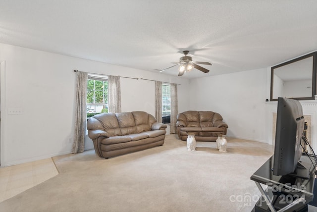 living room featuring a textured ceiling, ceiling fan, and carpet flooring