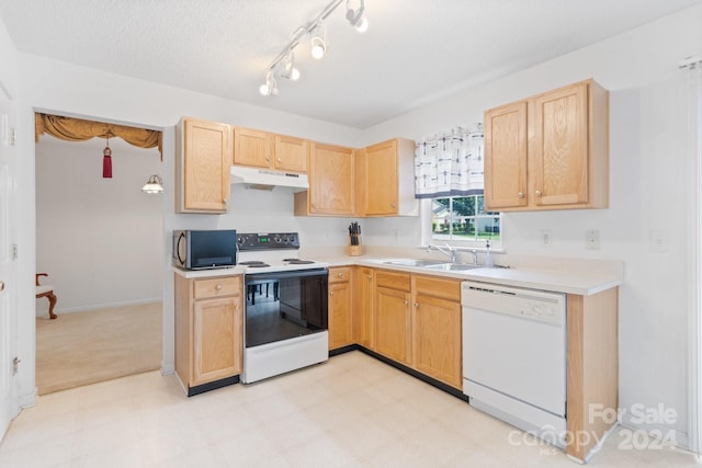 kitchen featuring white appliances, light brown cabinets, a textured ceiling, and sink