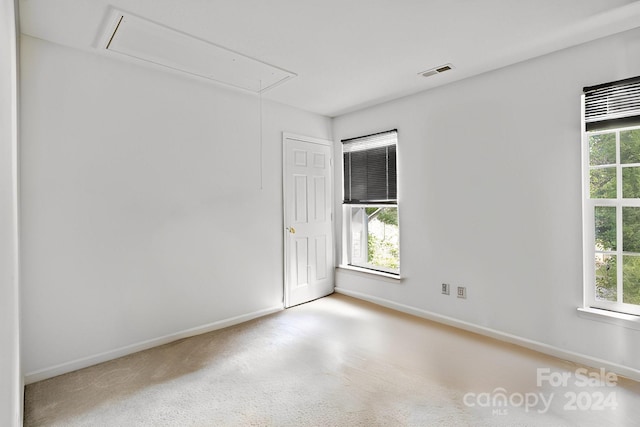 unfurnished room with light carpet