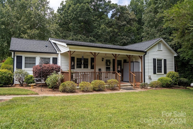 ranch-style home with covered porch and a front lawn