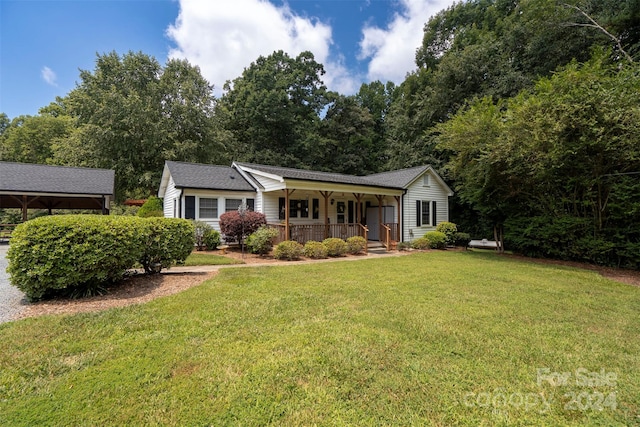 view of front of house with covered porch and a front yard