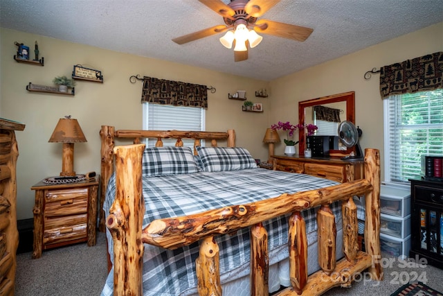 bedroom with carpet flooring, ceiling fan, and a textured ceiling