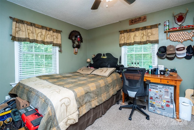 carpeted bedroom with ceiling fan and a textured ceiling