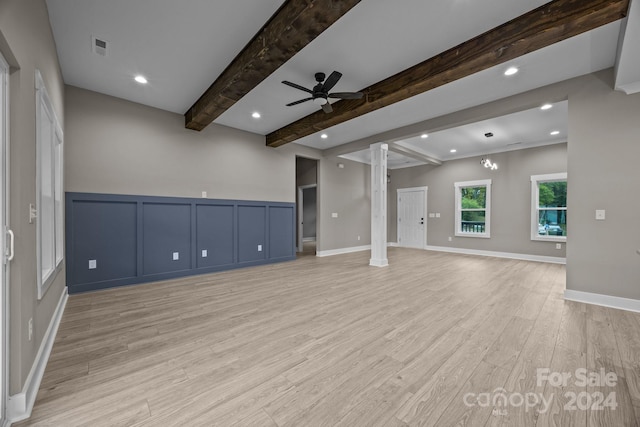 interior space featuring ceiling fan, decorative columns, beam ceiling, and light hardwood / wood-style floors