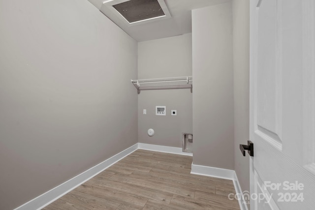 clothes washing area with hookup for a washing machine, light hardwood / wood-style floors, and electric dryer hookup