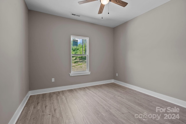 spare room with ceiling fan and light hardwood / wood-style flooring