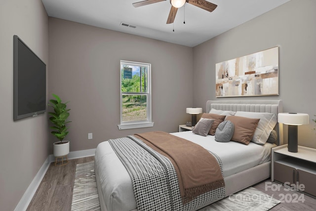 bedroom with wood-type flooring and ceiling fan