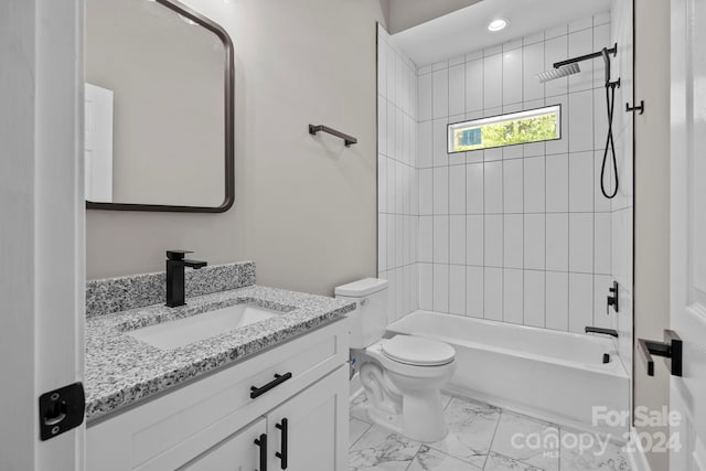 full bathroom featuring vanity, tiled shower / bath combo, and toilet