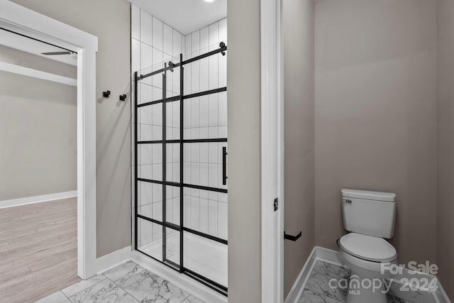 bathroom featuring hardwood / wood-style floors and toilet