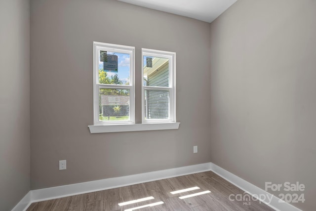 unfurnished room with light wood-type flooring