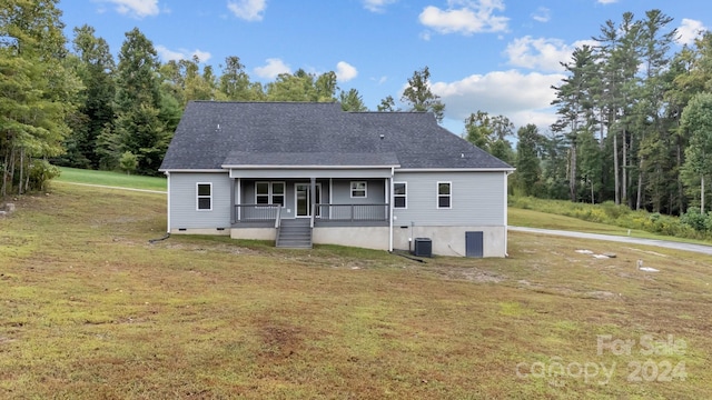 rear view of property with a lawn, central AC, and a porch