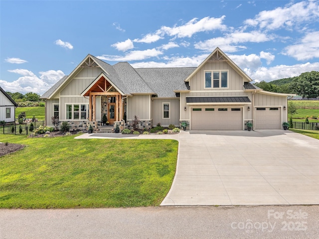 craftsman house featuring a garage and a front yard