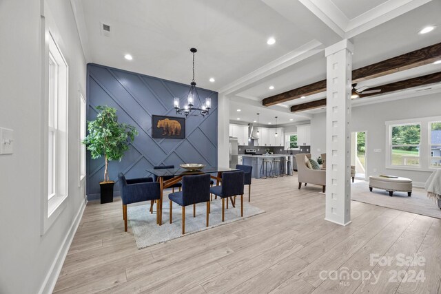 dining space featuring light wood-type flooring, ceiling fan with notable chandelier, beam ceiling, and crown molding