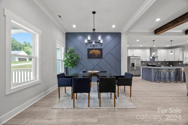 dining space featuring light wood-type flooring, crown molding, beam ceiling, and a notable chandelier