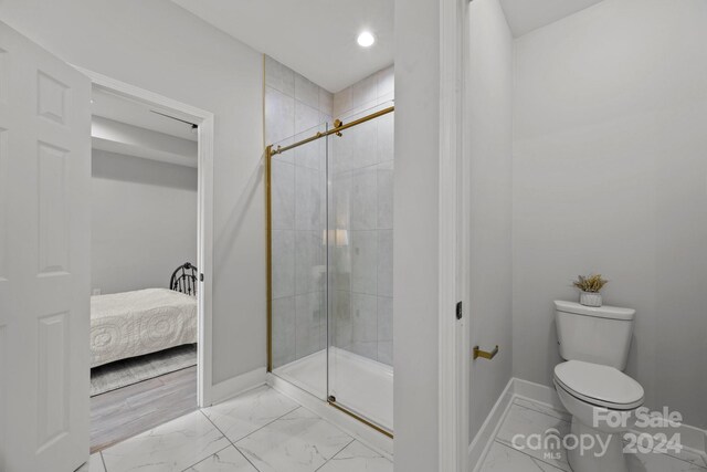 bathroom with walk in shower and toilet