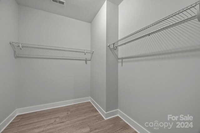 walk in closet featuring hardwood / wood-style floors