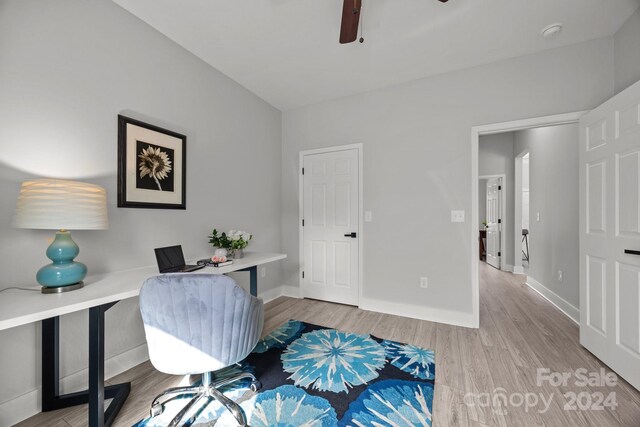 home office featuring light hardwood / wood-style floors and ceiling fan