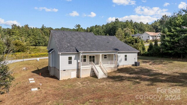 view of front of property featuring central AC and a front yard