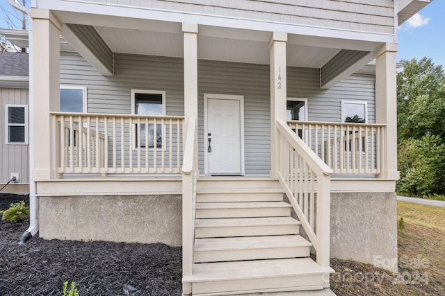 property entrance with covered porch