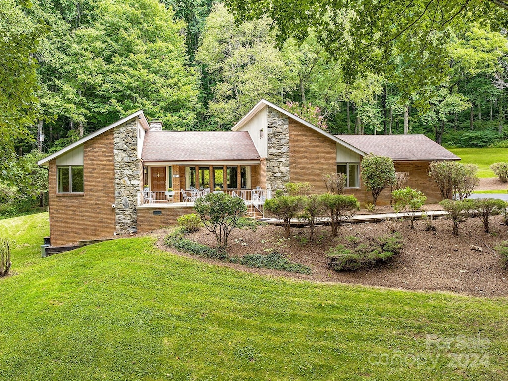 view of front of property with a front yard and a porch