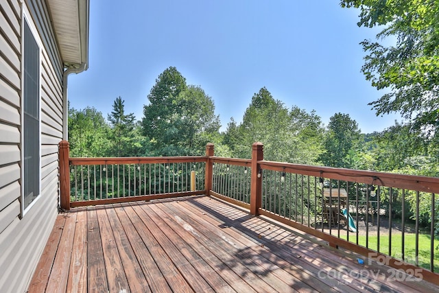 wooden terrace featuring a playground