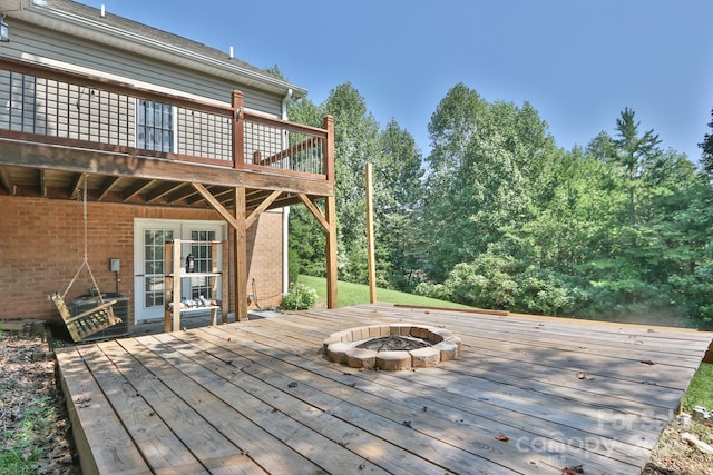 wooden deck with an outdoor fire pit