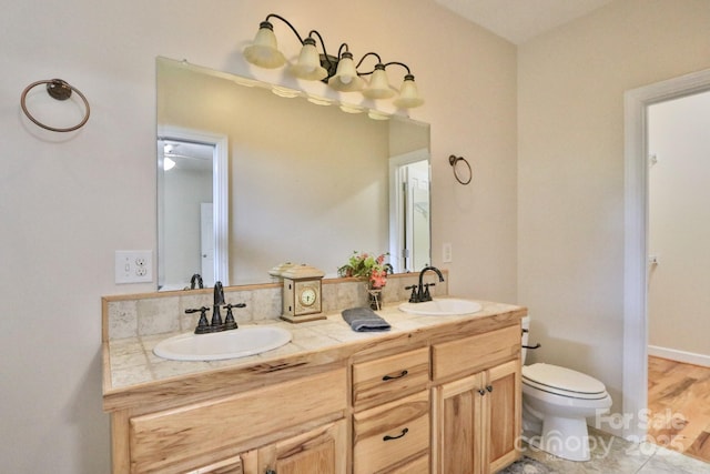 bathroom with tile patterned floors, vanity, and toilet