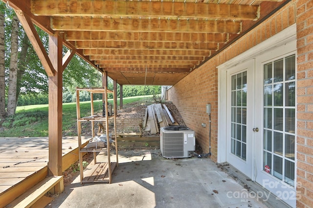 view of patio / terrace featuring french doors, central AC, and a wooden deck