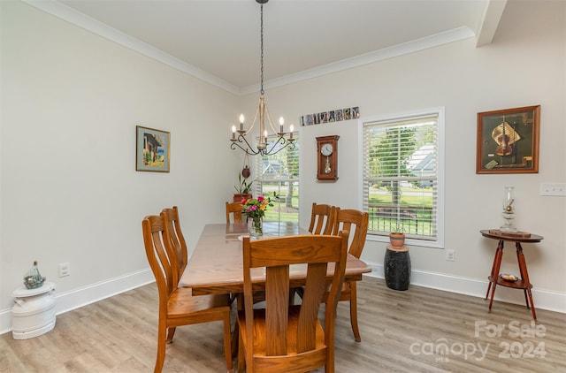 dining space featuring light hardwood / wood-style floors, a notable chandelier, and ornamental molding