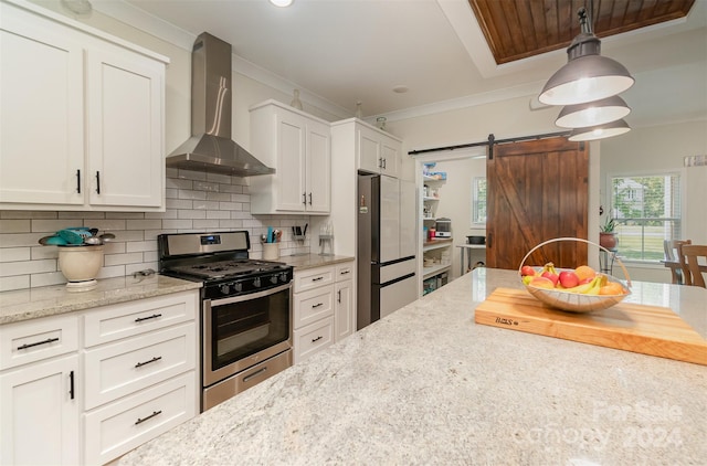 kitchen with wood ceiling, backsplash, stainless steel appliances, wall chimney exhaust hood, and a barn door