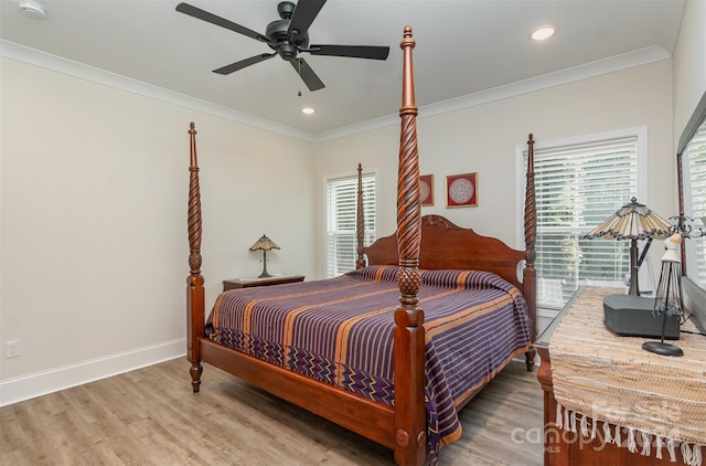 bedroom with ceiling fan, hardwood / wood-style flooring, and crown molding