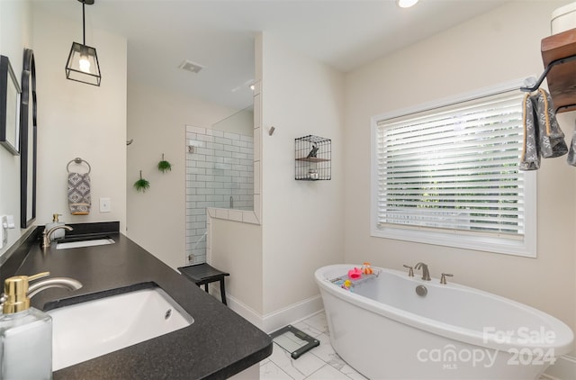 bathroom with vanity, plenty of natural light, separate shower and tub, and tile patterned floors