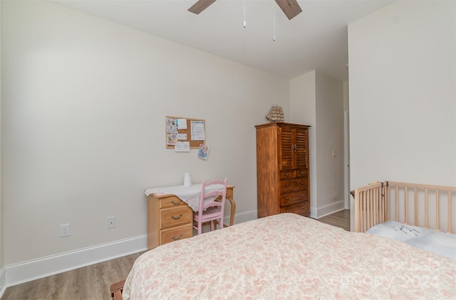 bedroom featuring hardwood / wood-style floors and ceiling fan