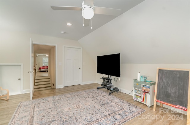 interior space with ceiling fan, light hardwood / wood-style floors, and vaulted ceiling